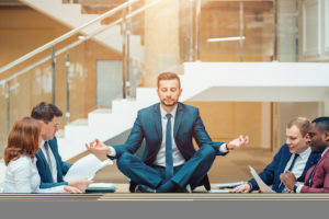 Jovem empresário a meditar no local de trabalho